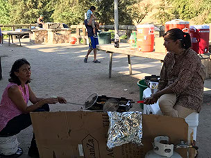 people barbequing at a 2017 Samaj picnic.