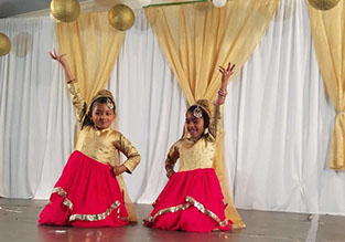 photo of 2 young girls dancing and performing at a Diwali show in 2017.